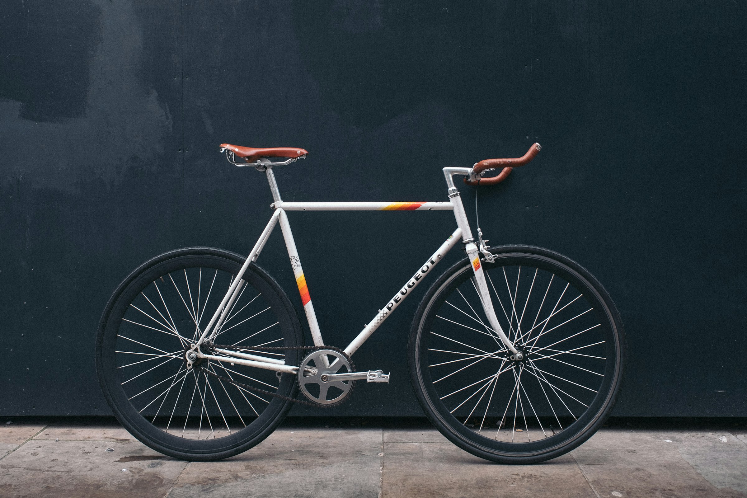 Road bicycle against a dark wall